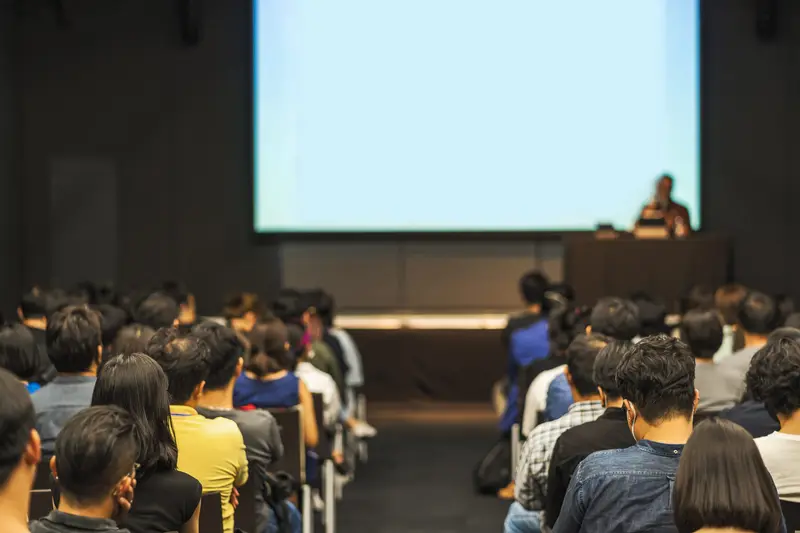 An audience following a talk in a lecture hall