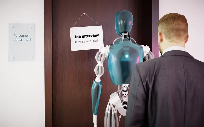 A robot waiting for a job interview behind a man in a suit